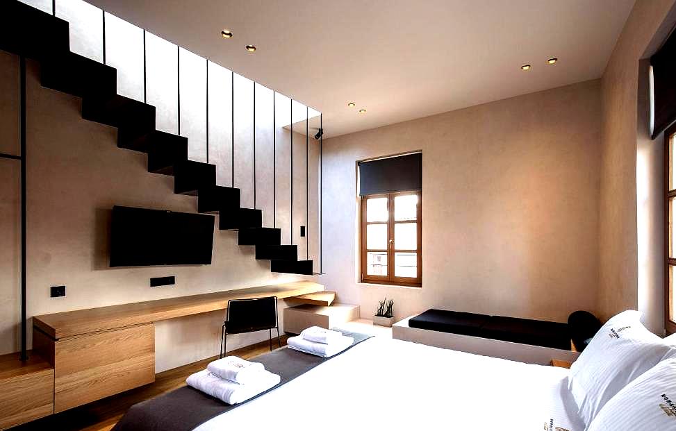 modern loft style room with minimalist design and wooden stairs