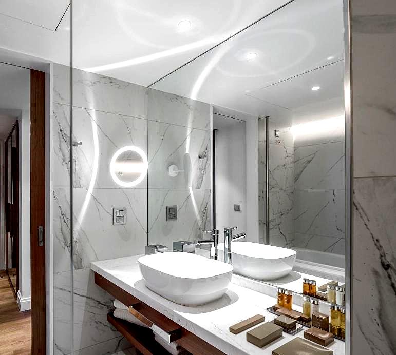 modern marble bathroom with double sinks and ambient lighting