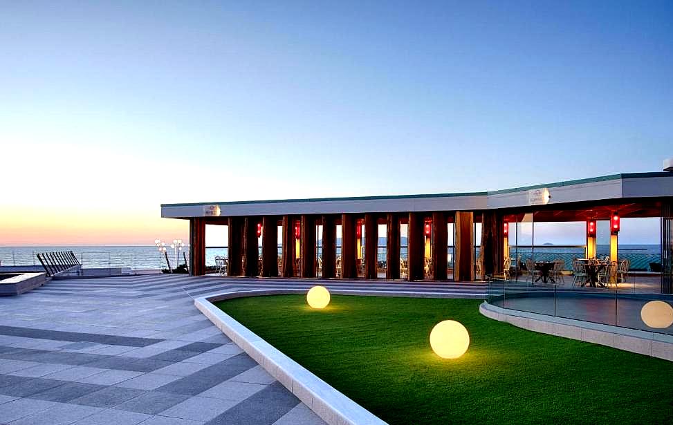 modern outdoor lounge with sea view and glowing sphere lights