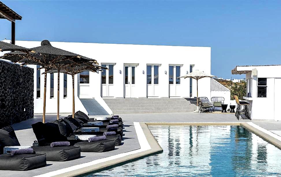 modern poolside area with lounge chairs and sea view