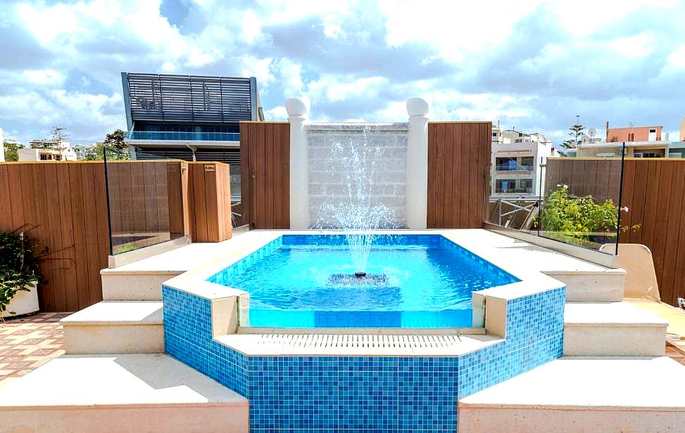 modern rooftop pool with fountain and city view