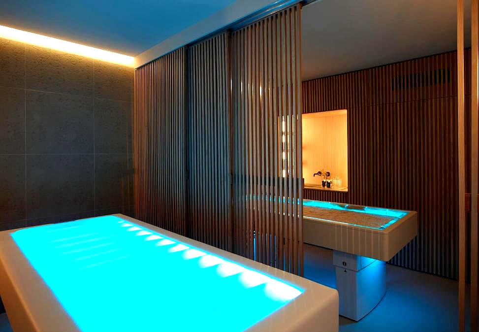 modern spa treatment room with glowing table