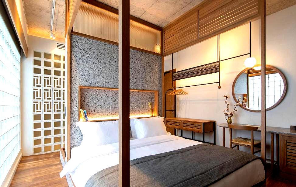 modern suite bedroom with wooden accents and textured walls