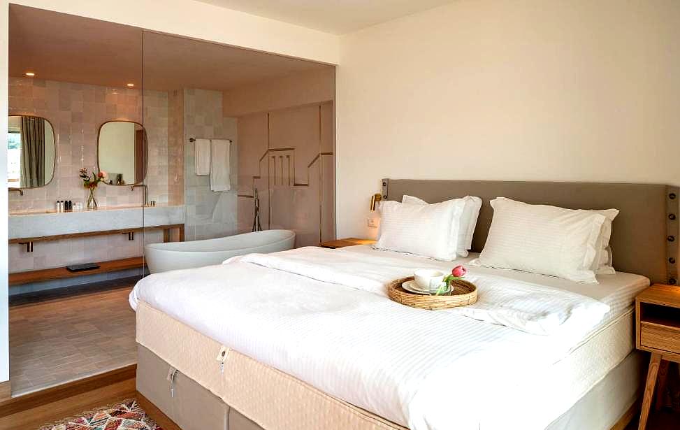 modern suite with ensuite bathroom and cozy bed