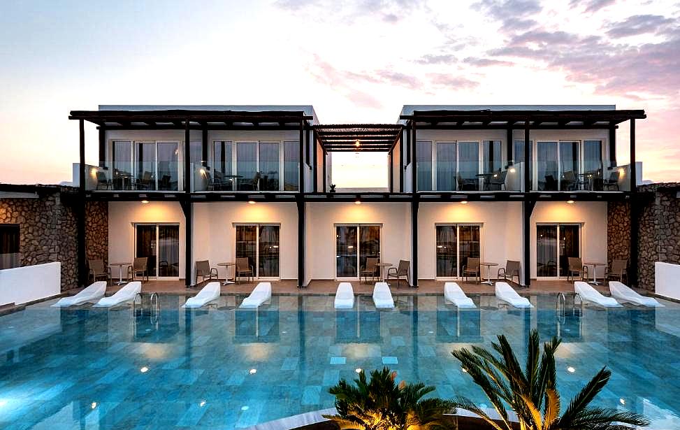 modern villas overlooking shared swimming pool at sunset