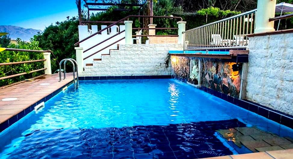 multi level pool with stone walls and lush surroundings