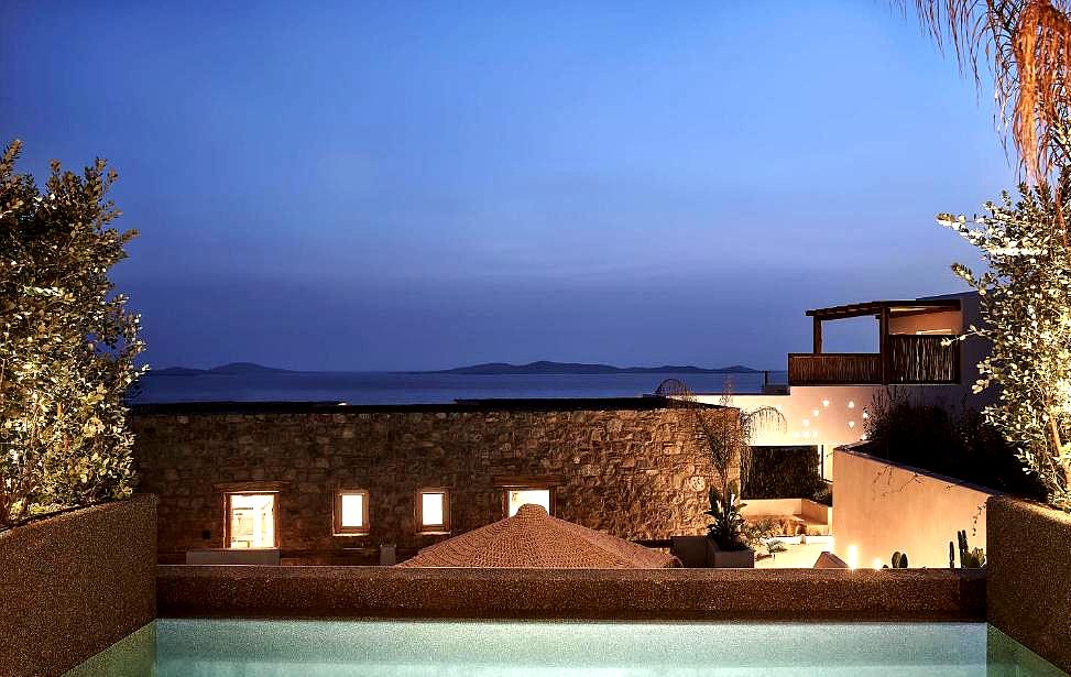 night view from private pool overlooking sea and hills