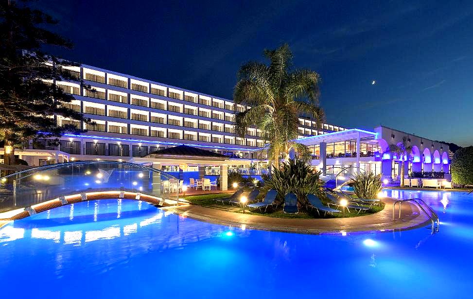 night view of resort with pool and lights