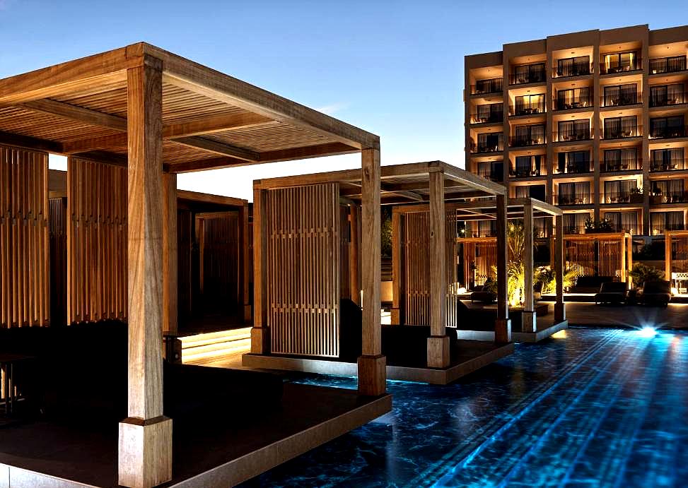 nighttime poolside cabanas with ambient lighting at hotel