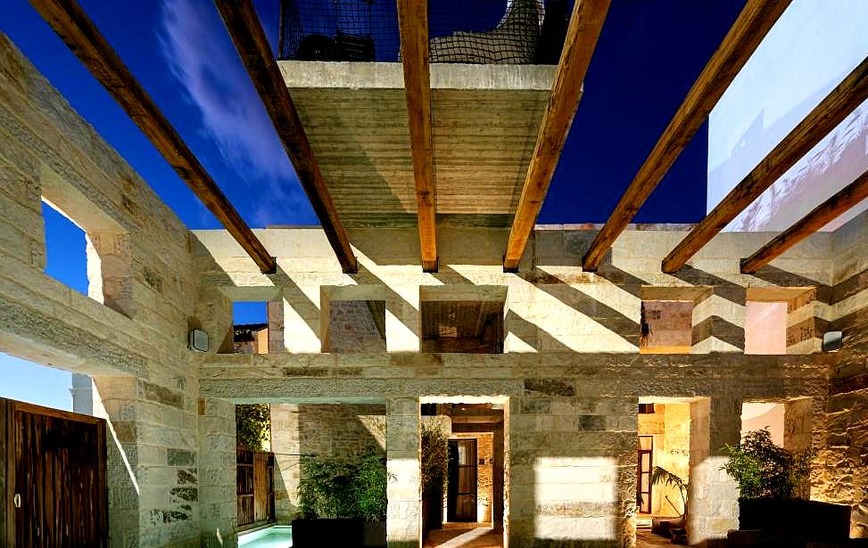 open air courtyard with wooden beams and stone architecture