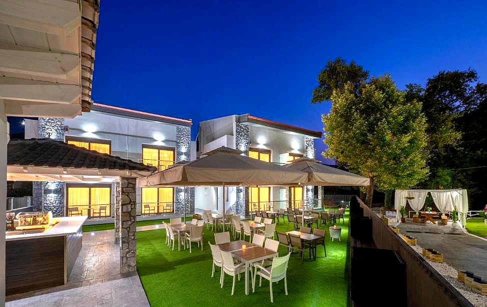 outdoor dining area with large umbrellas and modern lighting