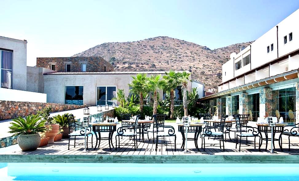 outdoor dining area with pool and mountain view