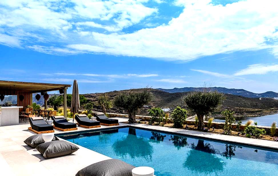 outdoor pool area with lounge chairs and mountain view