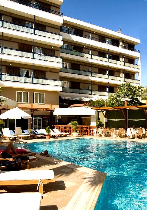 outdoor pool area with sun loungers and umbrellas