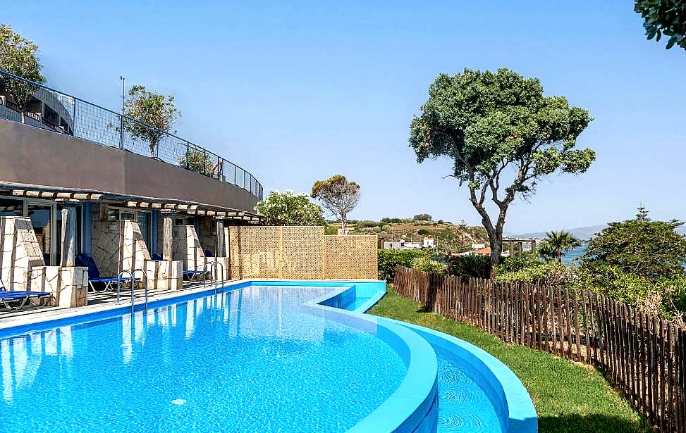 outdoor pool with lush greenery and sea view