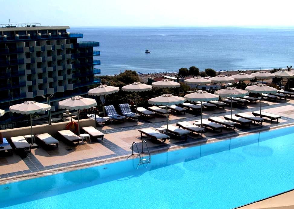 outdoor pool with sea view and sun loungers