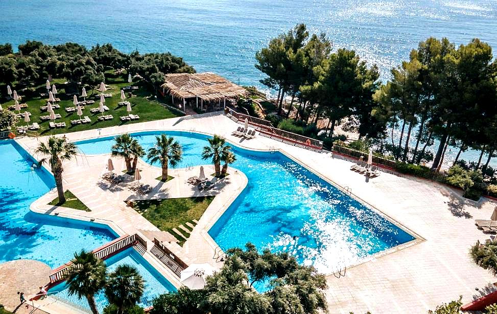 outdoor pool with sea view and sun loungers