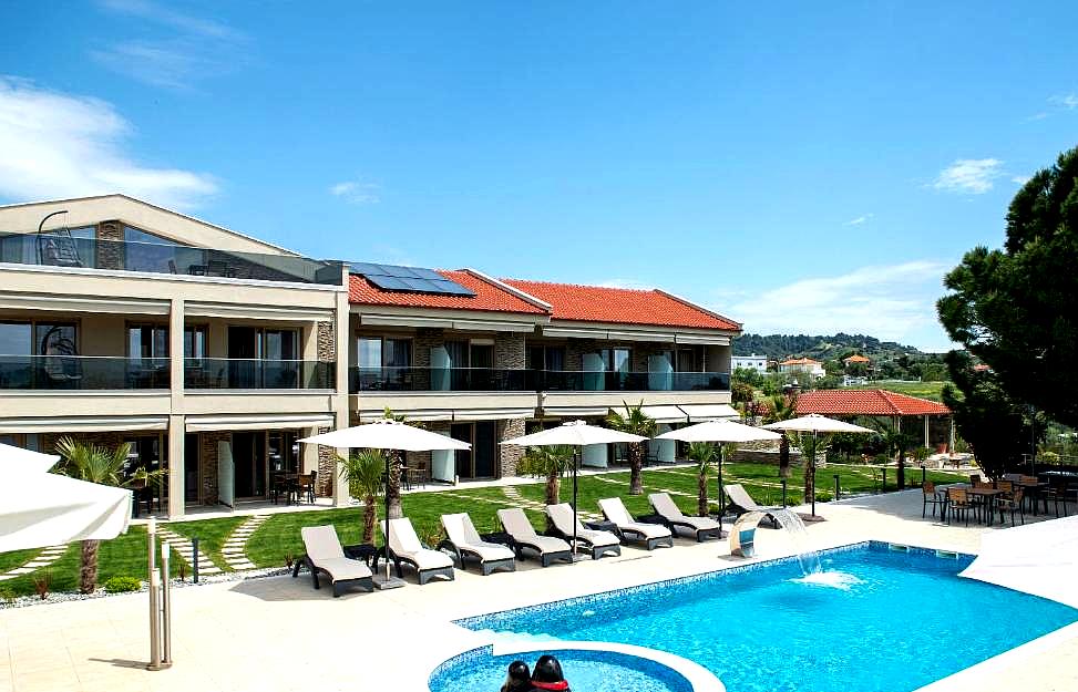 outdoor swimming pool area with lounge chairs and sun umbrellas