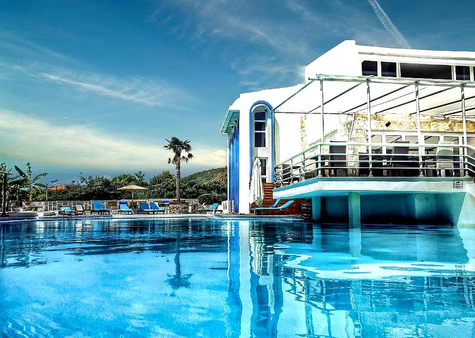 outdoor swimming pool with cabana and sea view