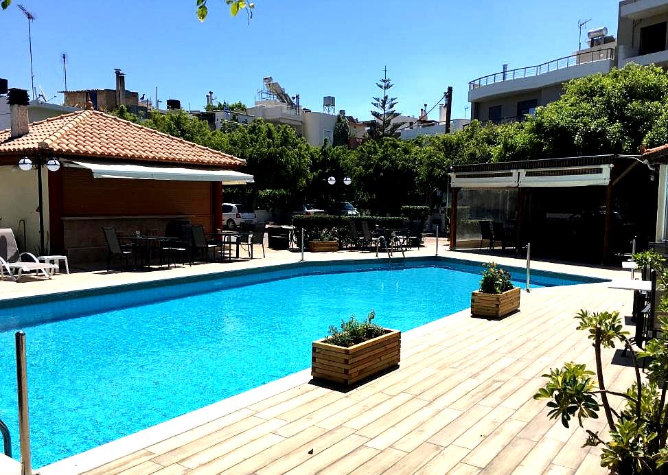 outdoor swimming pool with poolside seating and plants