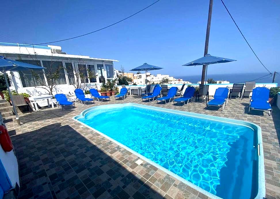 outdoor swimming pool with sun loungers and sea view