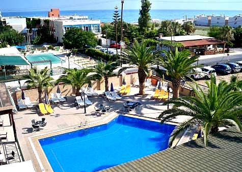 palm lined pool area with sea view and sun loungers