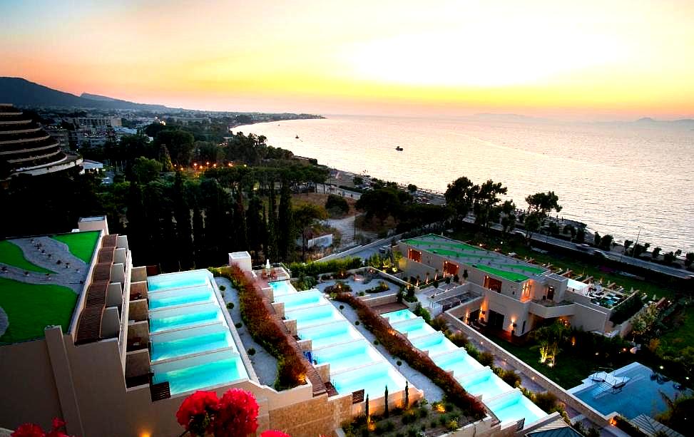 panoramic sea view with multiple private pools at sunset