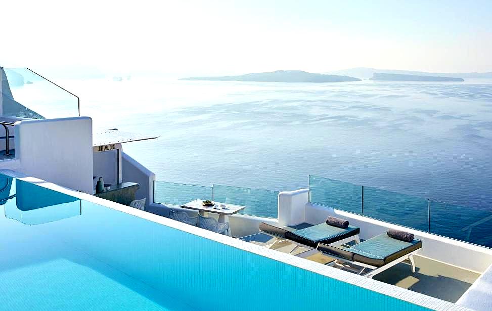 pool and sun loungers overlooking sea