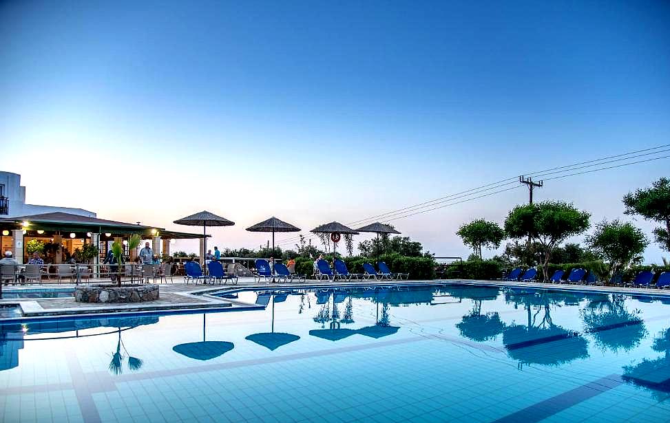 poolside bar area with sun loungers and evening sky