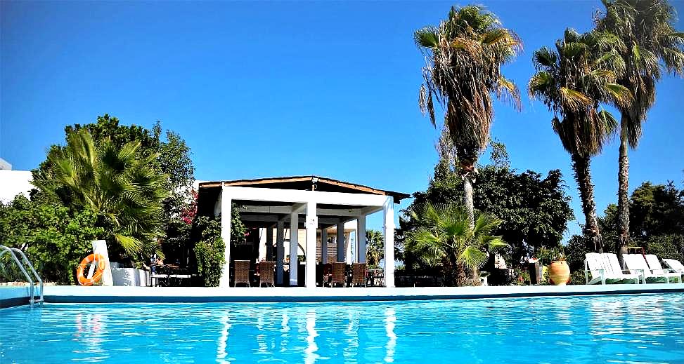 poolside dining area with palm trees