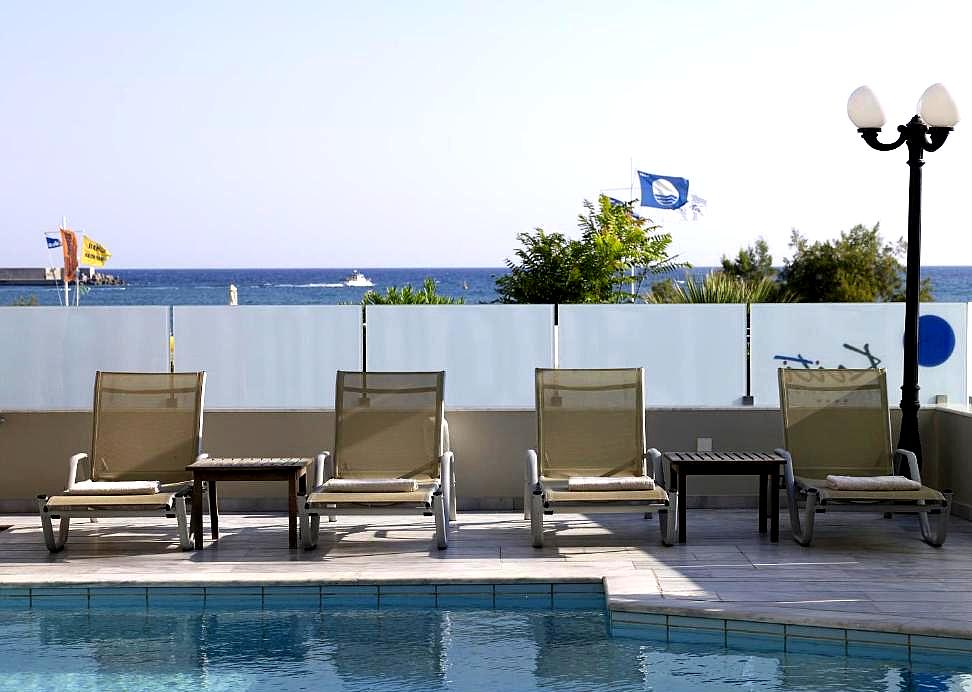 poolside loungers with clear sea view and blue sky