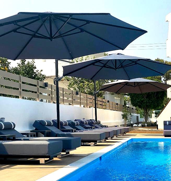 poolside sun loungers with large umbrellas