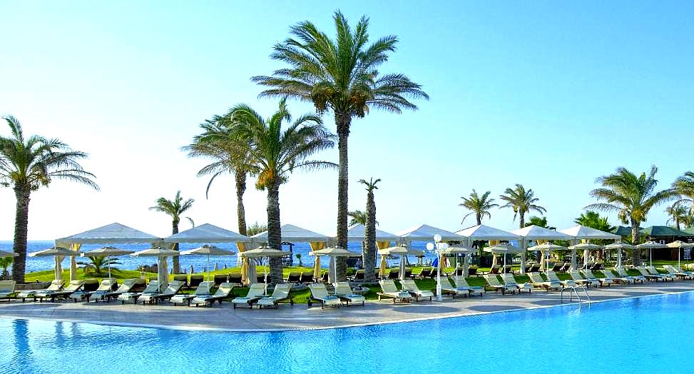 poolside sunbeds overlooking sea