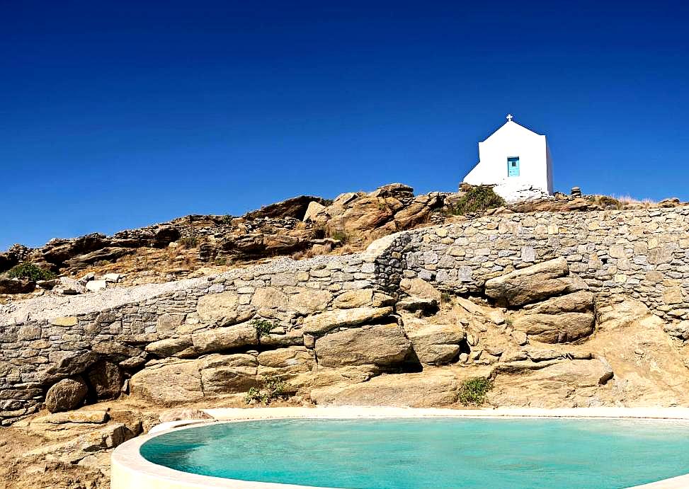 poolside with hilltop chapel