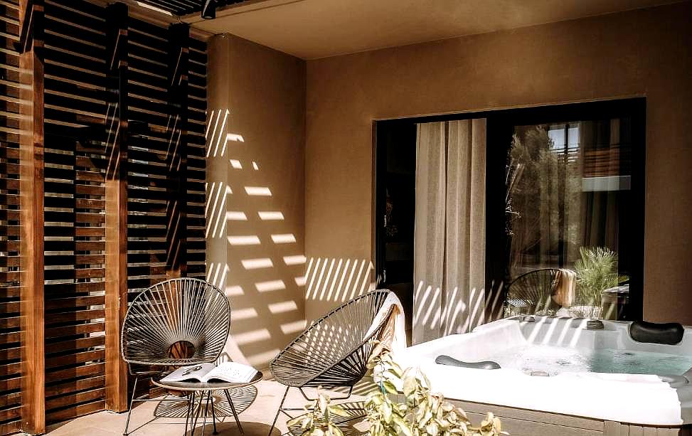 private patio with hot tub and seating