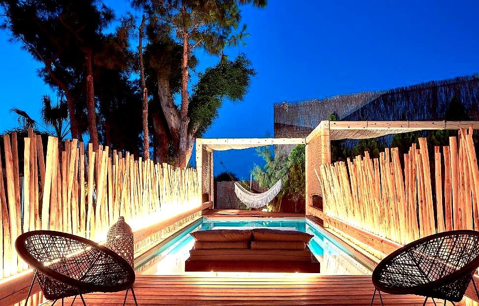 private pool with hammock and deck chairs