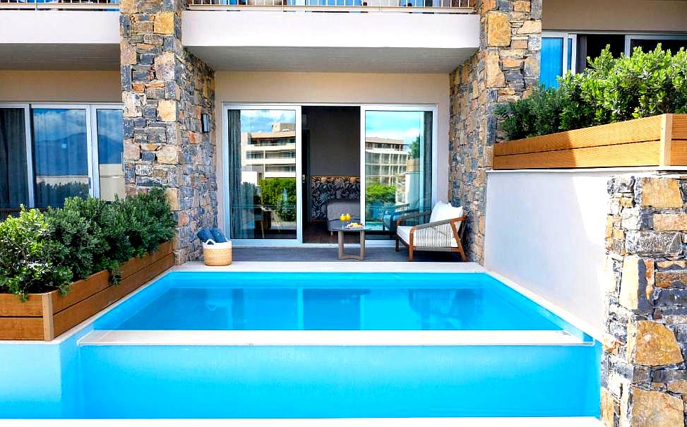 private pool with stone accents and cozy patio