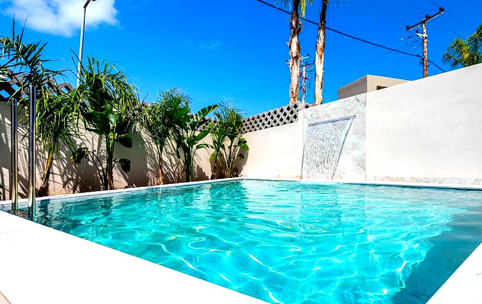 private pool with waterfall and plants