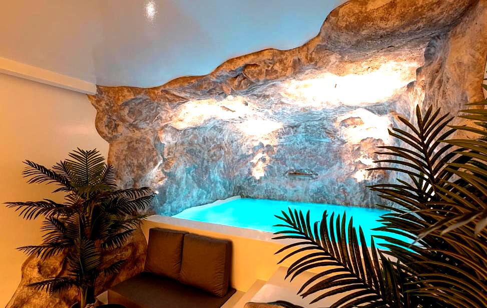 relaxing indoor pool in a cave like setting with soft lighting