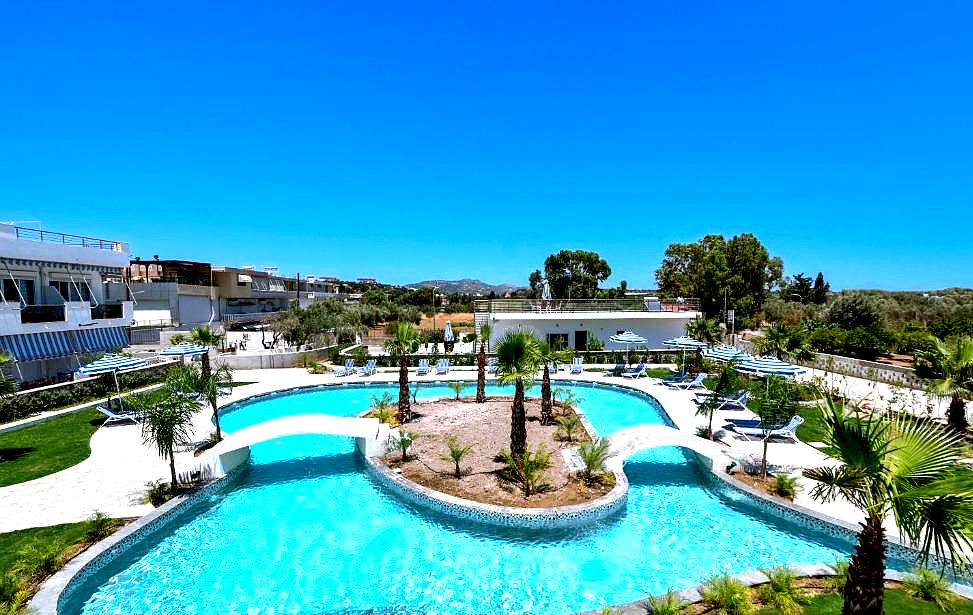 resort pool with palm trees and sun loungers