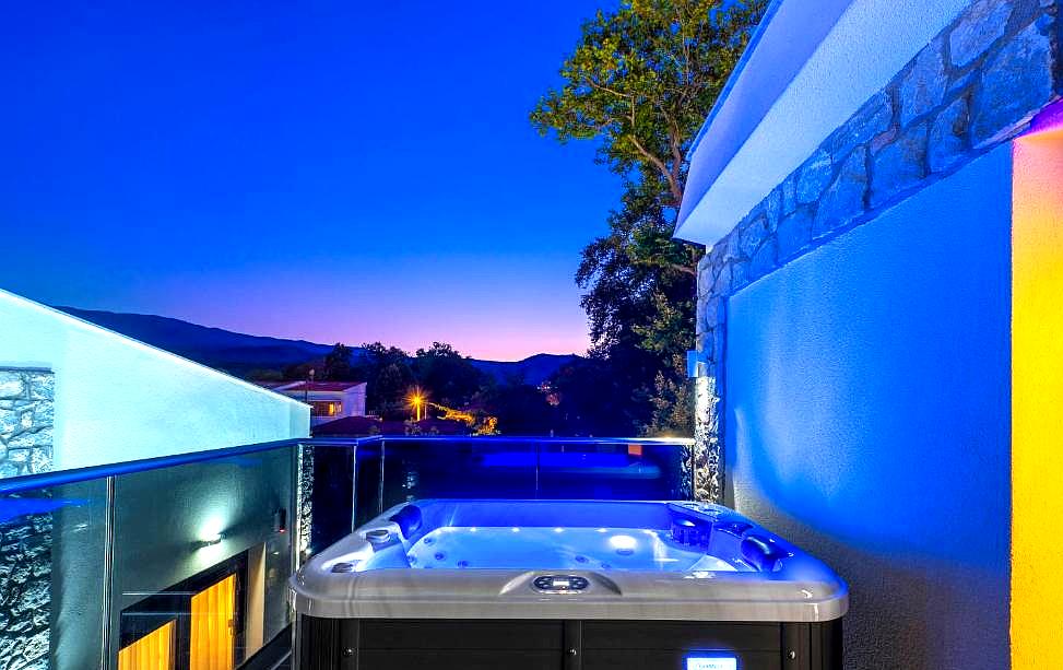 rooftop hot tub with stunning sea view at dusk