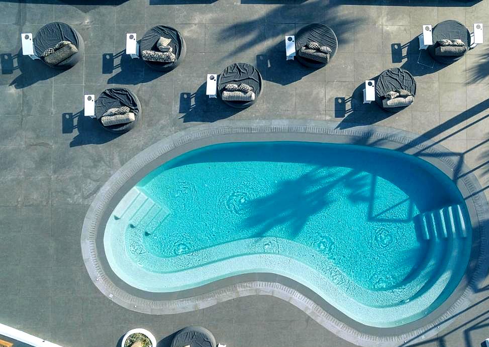 rooftop pool surrounded by modern lounge beds