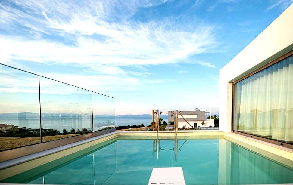 rooftop pool with glass walls and sea view