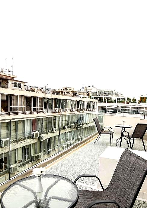 rooftop terrace with city view and seating