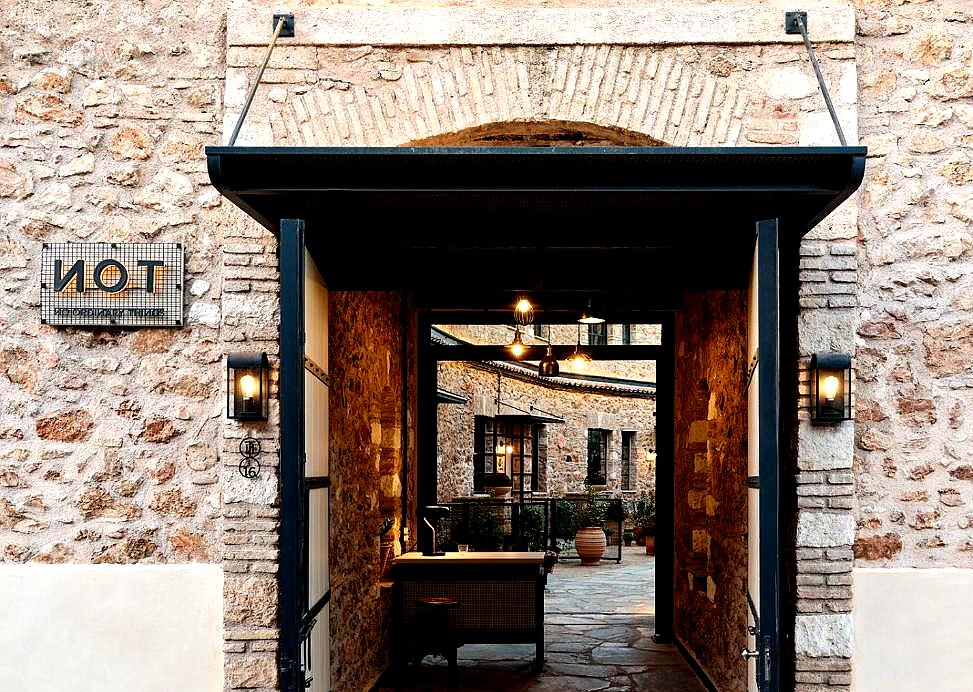 rustic hotel entrance with exposed stone walls