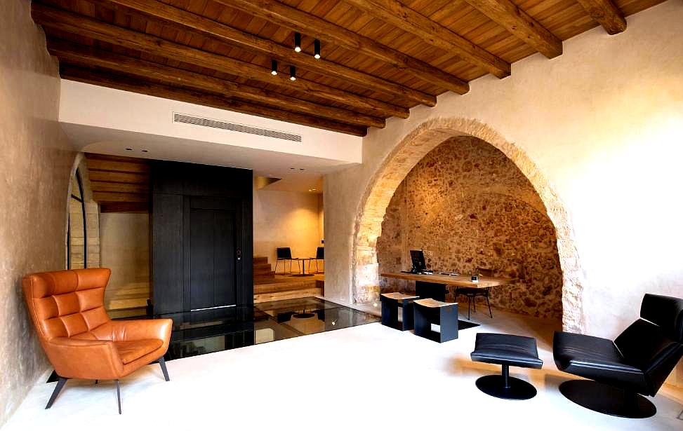 rustic lobby with exposed stone archways and modern seating