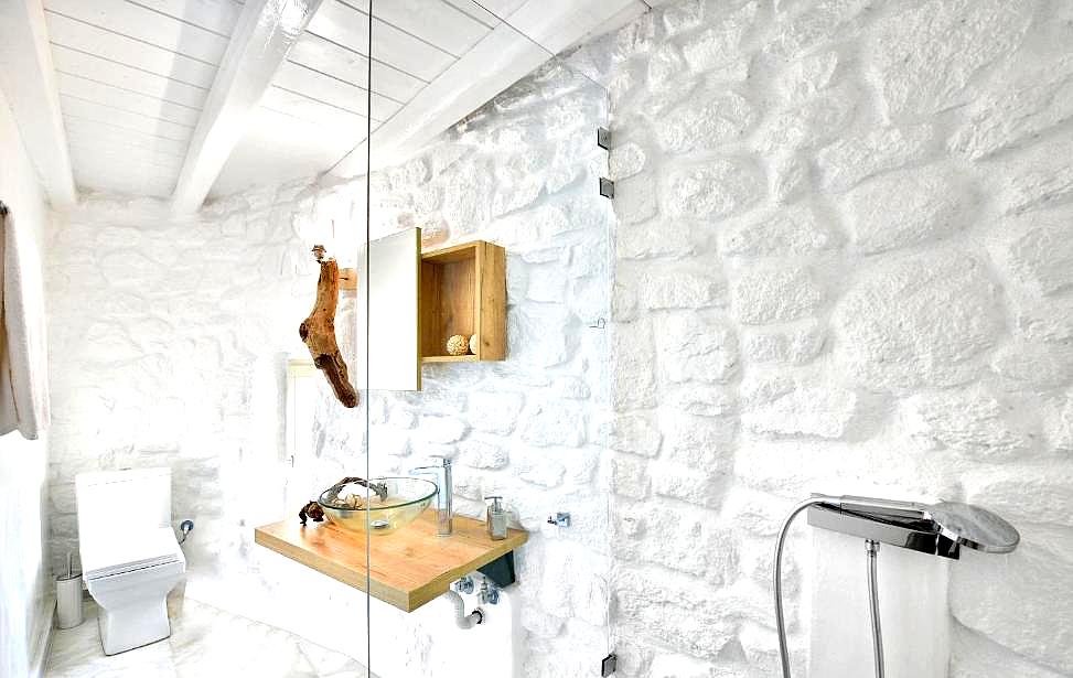 rustic white stone bathroom with modern fixtures