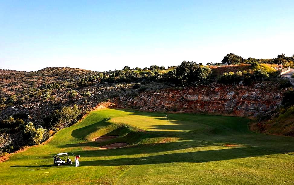 scenic golf course surrounded by hills and greenery