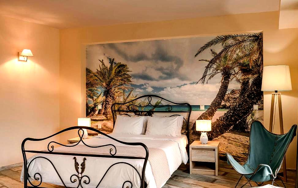 sea view bedroom with beach mural and iron bed frame