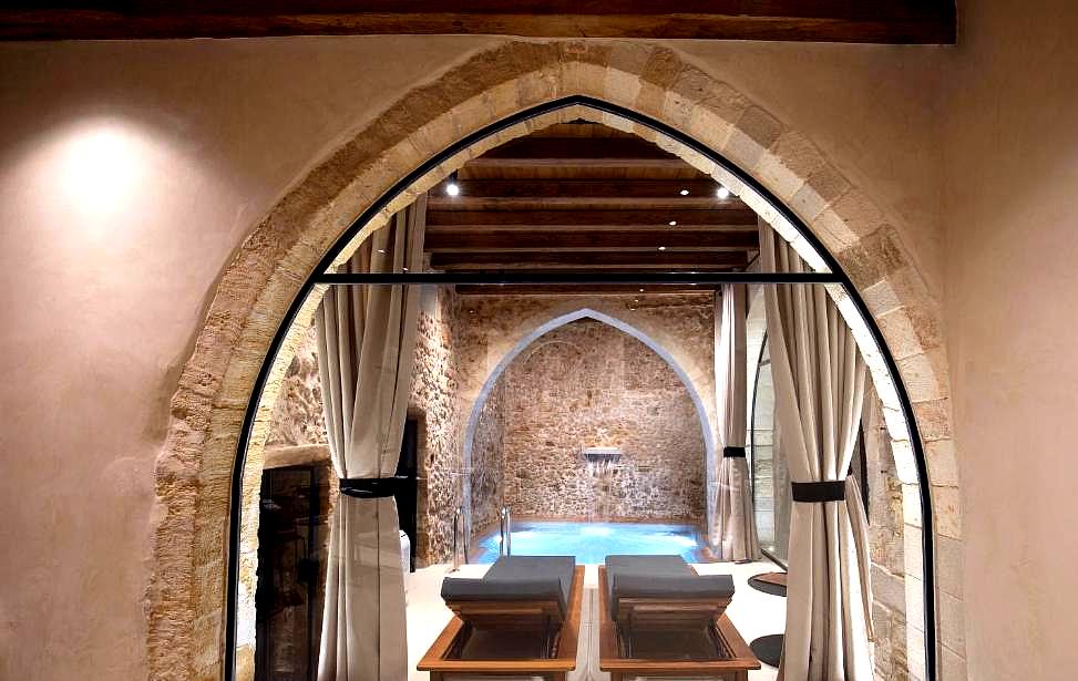 serene indoor pool with stone walls and arched entry